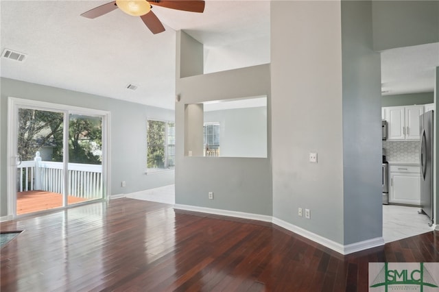 unfurnished living room with ceiling fan and light wood-type flooring