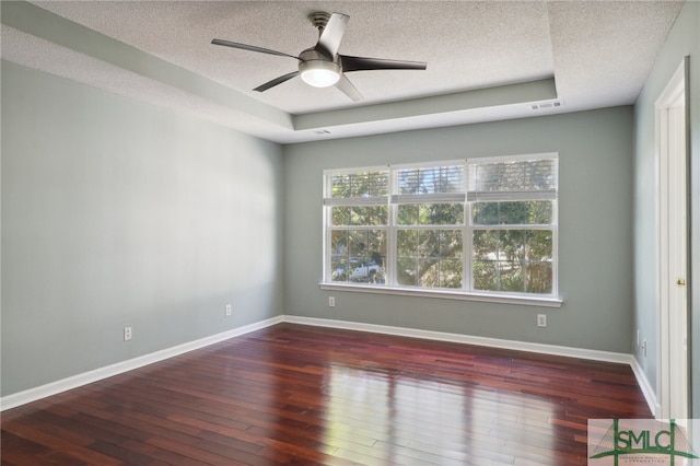 unfurnished room featuring a textured ceiling, ceiling fan, and dark hardwood / wood-style floors