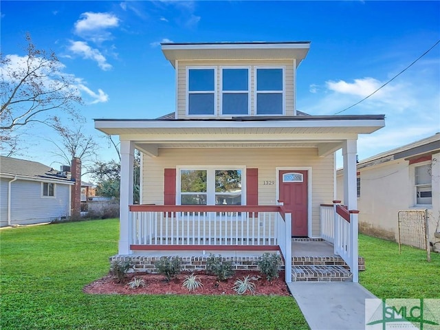 view of front of home with covered porch and a front lawn