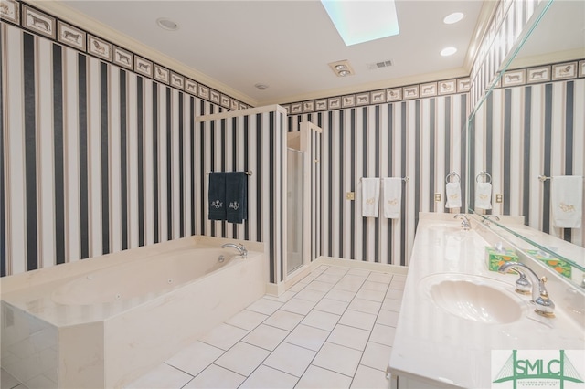 bathroom featuring tile patterned flooring, vanity, shower with separate bathtub, and a skylight