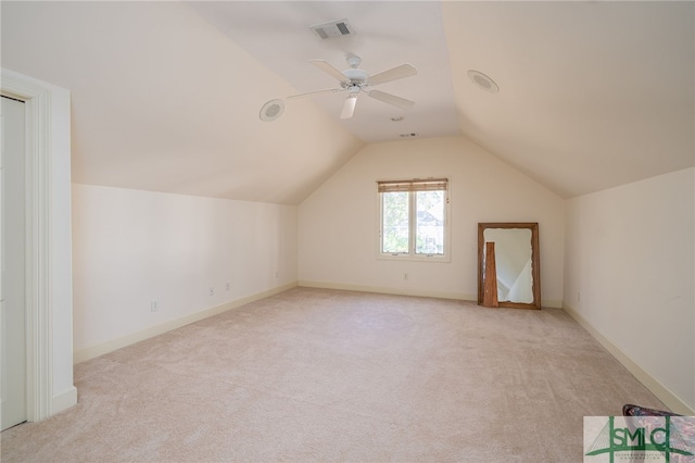 additional living space with light carpet, lofted ceiling, and ceiling fan