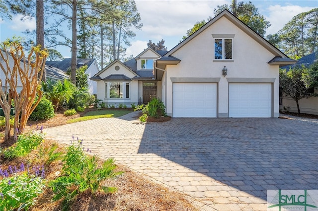 view of front of home with a mountain view and a garage