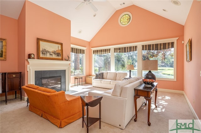 living room with ceiling fan, high vaulted ceiling, light carpet, and a fireplace