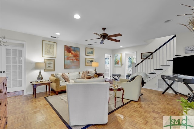 living room with ceiling fan and light parquet flooring