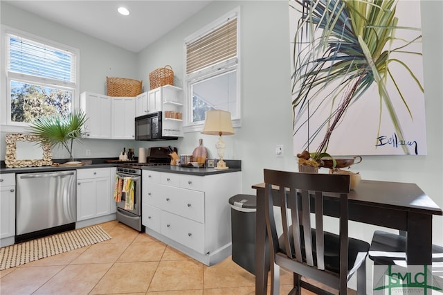 kitchen featuring white cabinetry, light tile patterned floors, and stainless steel appliances