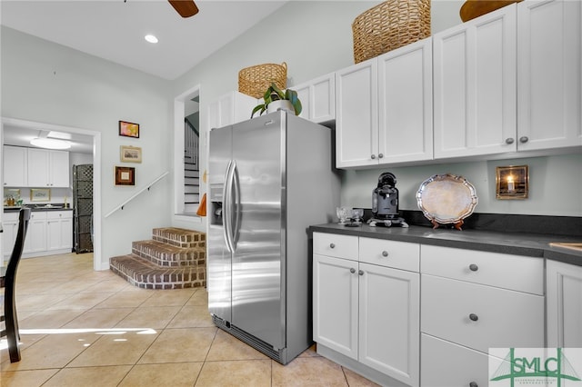 kitchen featuring white cabinets and stainless steel fridge