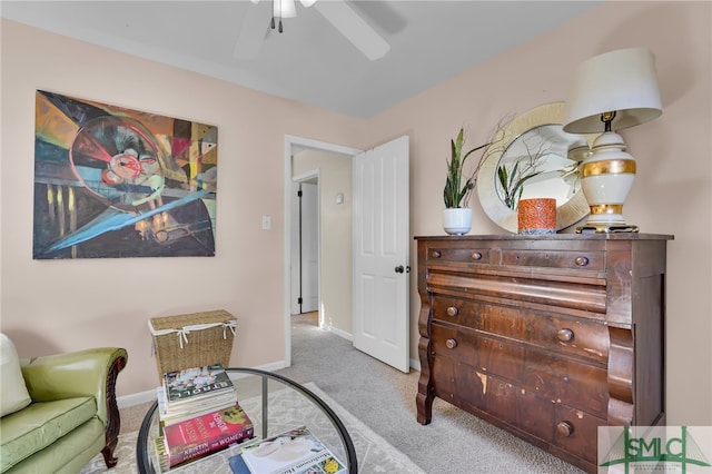 sitting room featuring light carpet and ceiling fan