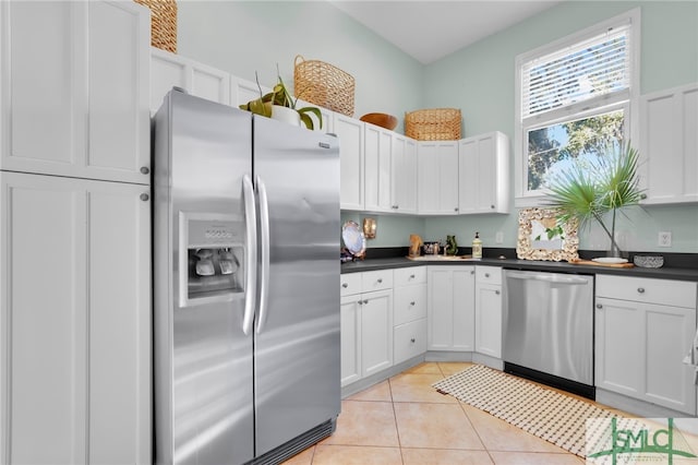 kitchen featuring white cabinets, light tile patterned floors, and appliances with stainless steel finishes