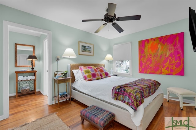 bedroom with hardwood / wood-style floors and ceiling fan