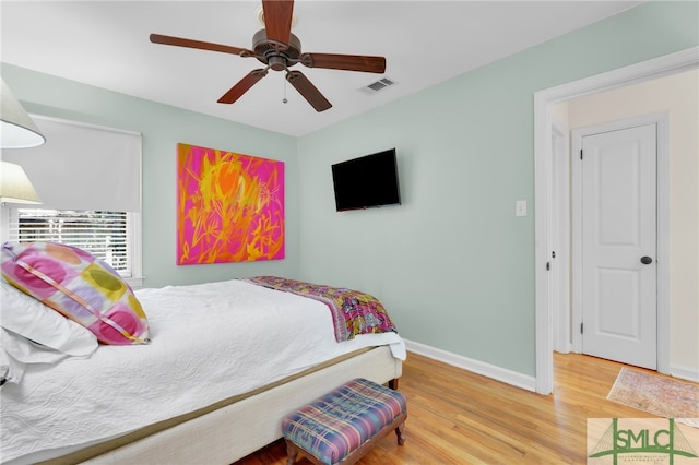 bedroom with wood-type flooring and ceiling fan