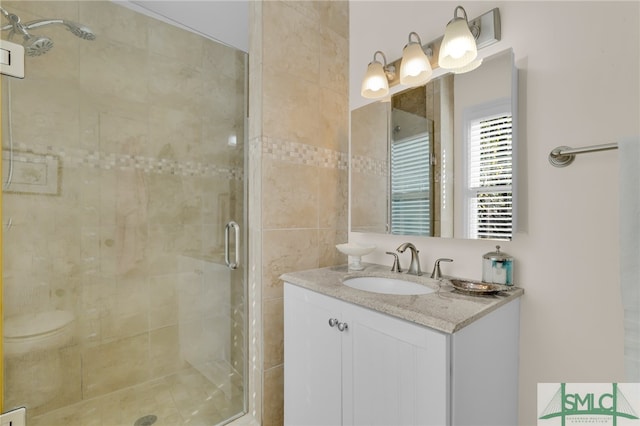 bathroom featuring vanity, toilet, and walk in shower