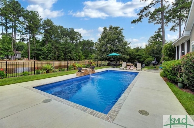 view of swimming pool with pool water feature and a patio