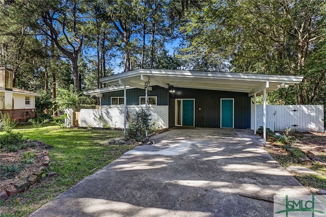 ranch-style house with a carport and a front yard