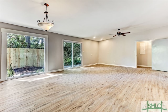 unfurnished living room featuring ceiling fan and light hardwood / wood-style flooring