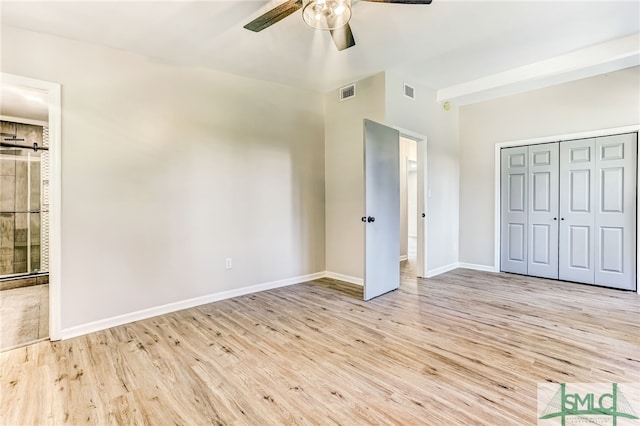 unfurnished bedroom featuring a closet, light hardwood / wood-style floors, and ceiling fan