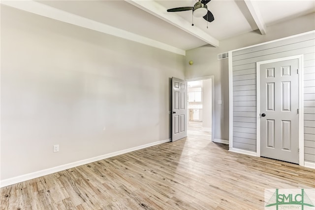 unfurnished bedroom with beam ceiling, light hardwood / wood-style flooring, and ceiling fan