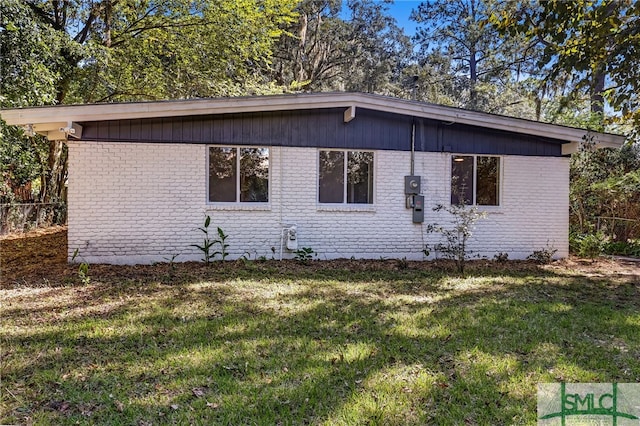 view of side of home featuring a yard