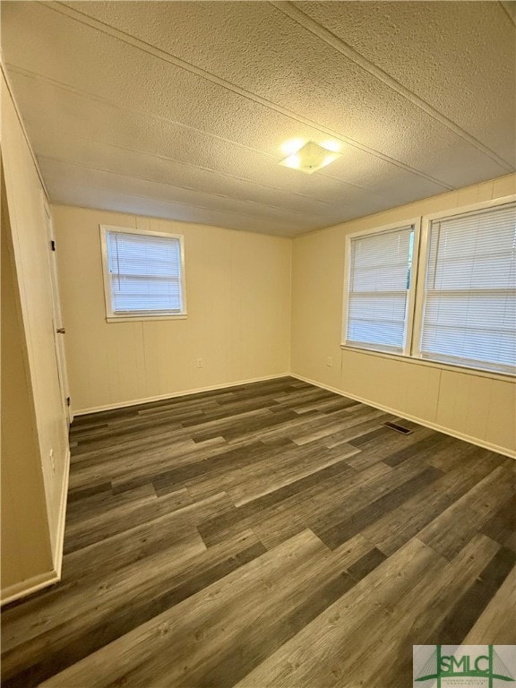 4192 Halcyondale Rd, Sylvania, GA 30467 - empty room with a textured ceiling and dark hardwood / wood-style floors