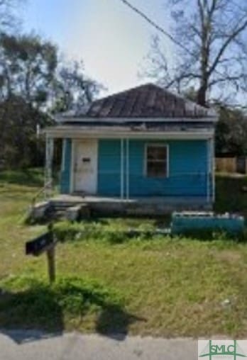 bungalow-style home with a front yard