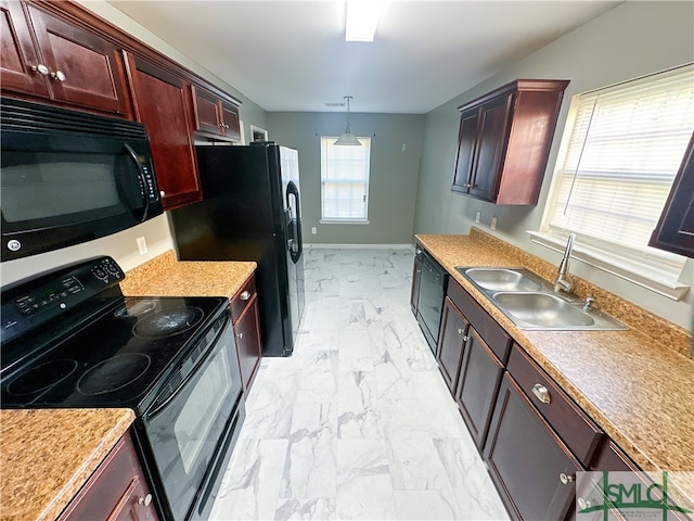 kitchen featuring black appliances, decorative light fixtures, plenty of natural light, and sink