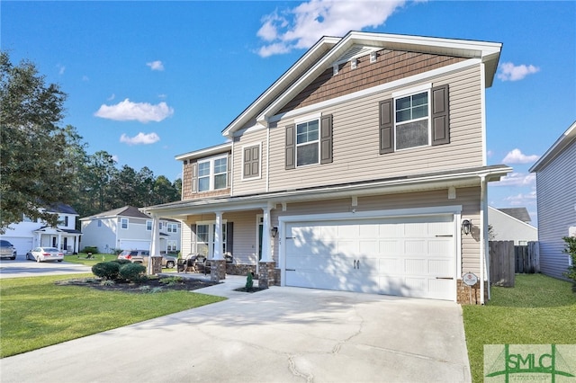 view of front of house featuring covered porch, a front yard, and a garage