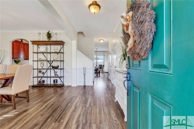 foyer featuring crown molding and dark hardwood / wood-style floors