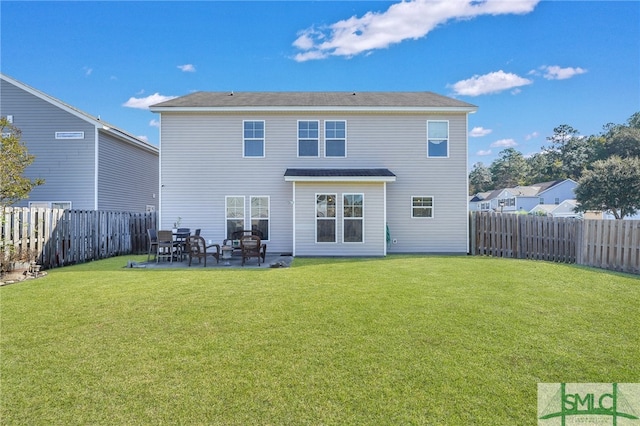 back of property with a patio area and a yard