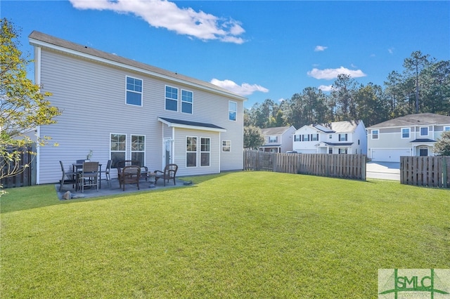 back of house with a patio area and a lawn