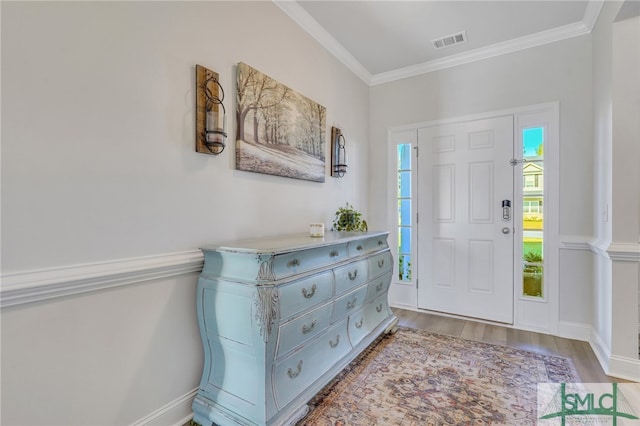 foyer entrance featuring light hardwood / wood-style flooring and ornamental molding