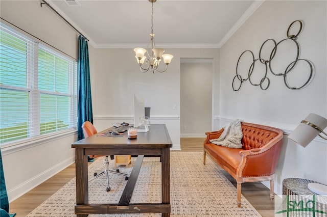 office featuring crown molding, plenty of natural light, an inviting chandelier, and hardwood / wood-style flooring