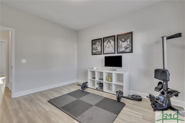 workout room featuring light wood-type flooring