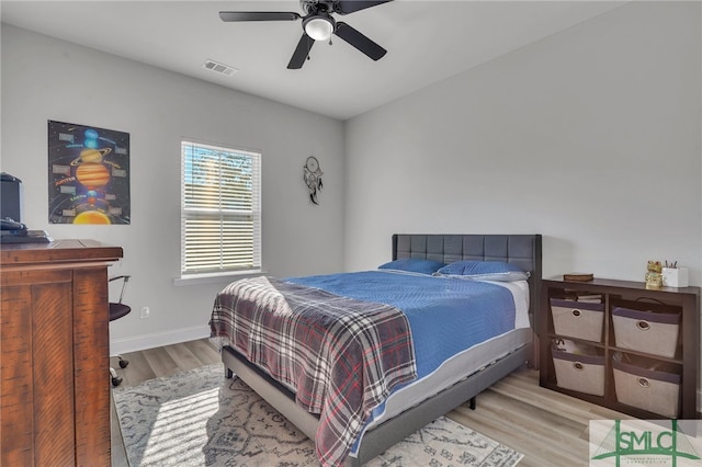 bedroom with ceiling fan and light hardwood / wood-style floors