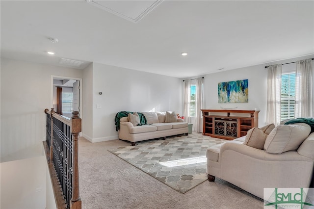 living room with a healthy amount of sunlight and light colored carpet