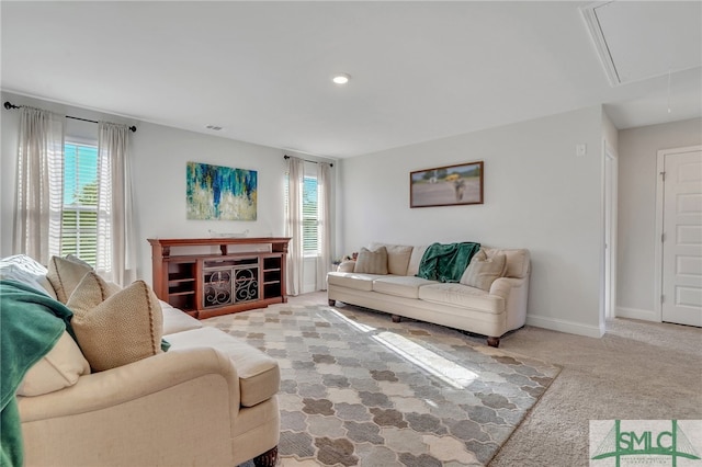 living room featuring plenty of natural light and light colored carpet