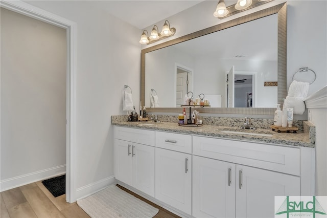 bathroom with vanity and hardwood / wood-style flooring