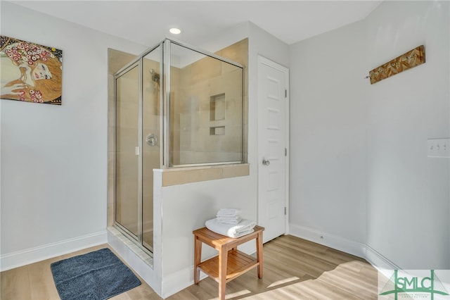 bathroom with wood-type flooring and walk in shower