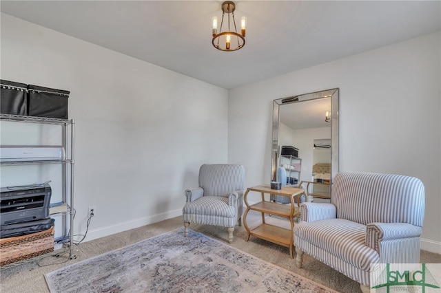 sitting room with carpet flooring and an inviting chandelier