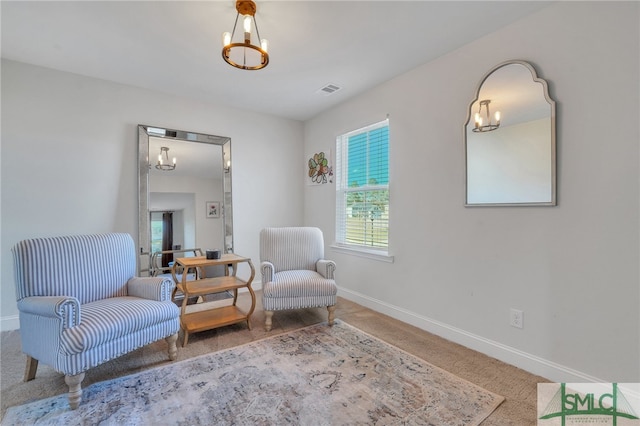 sitting room with carpet flooring and a chandelier