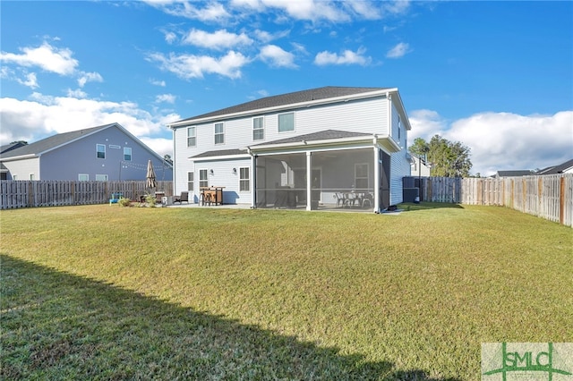 back of house with a lawn, a sunroom, and a patio