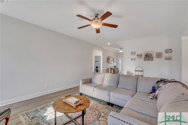 living room featuring ceiling fan and hardwood / wood-style flooring