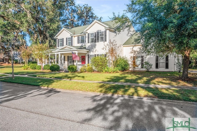 view of front of house featuring covered porch and a front lawn