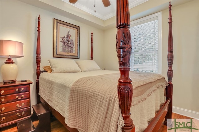 bedroom with wood-type flooring, ceiling fan, and crown molding