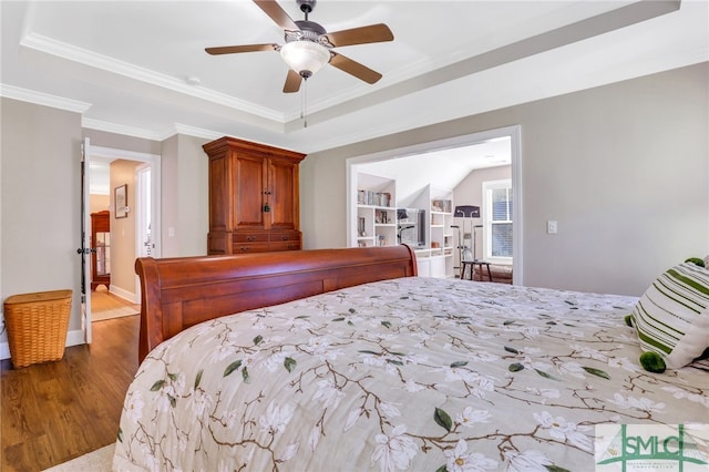 bedroom featuring ceiling fan, ornamental molding, and hardwood / wood-style flooring