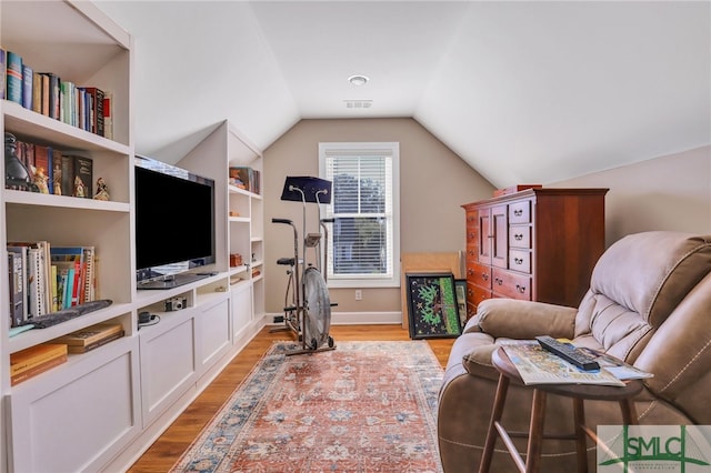 sitting room featuring hardwood / wood-style floors and lofted ceiling