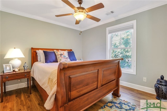 bedroom with multiple windows, ceiling fan, dark hardwood / wood-style floors, and ornamental molding