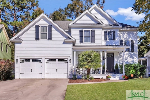 view of front of property featuring covered porch, a front yard, and a garage