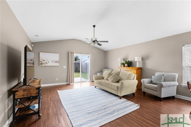 living room with ceiling fan, dark wood-type flooring, and vaulted ceiling