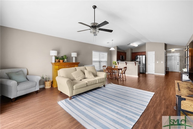 living room featuring dark hardwood / wood-style flooring, ceiling fan, and lofted ceiling