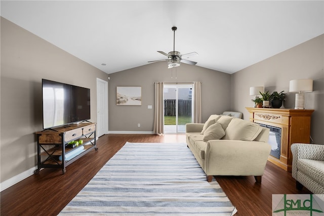 living room with dark hardwood / wood-style floors, ceiling fan, and vaulted ceiling