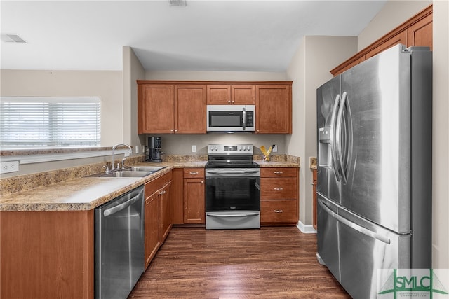 kitchen with dark hardwood / wood-style flooring, sink, stainless steel appliances, and vaulted ceiling